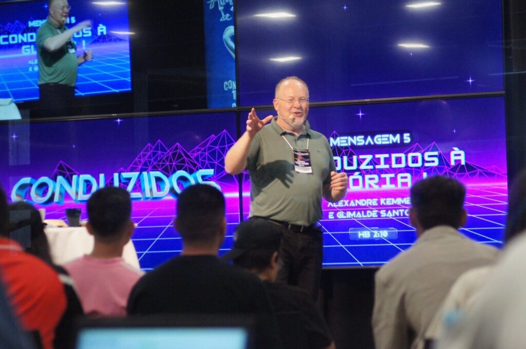 Brother delivering the message at the Youth Conference with the audience listening attentively