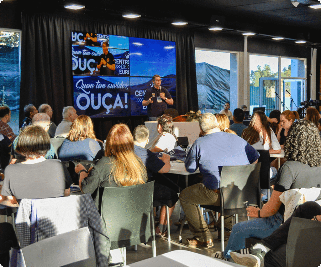 Brother delivering the message at the European Conference with the audience listening attentively