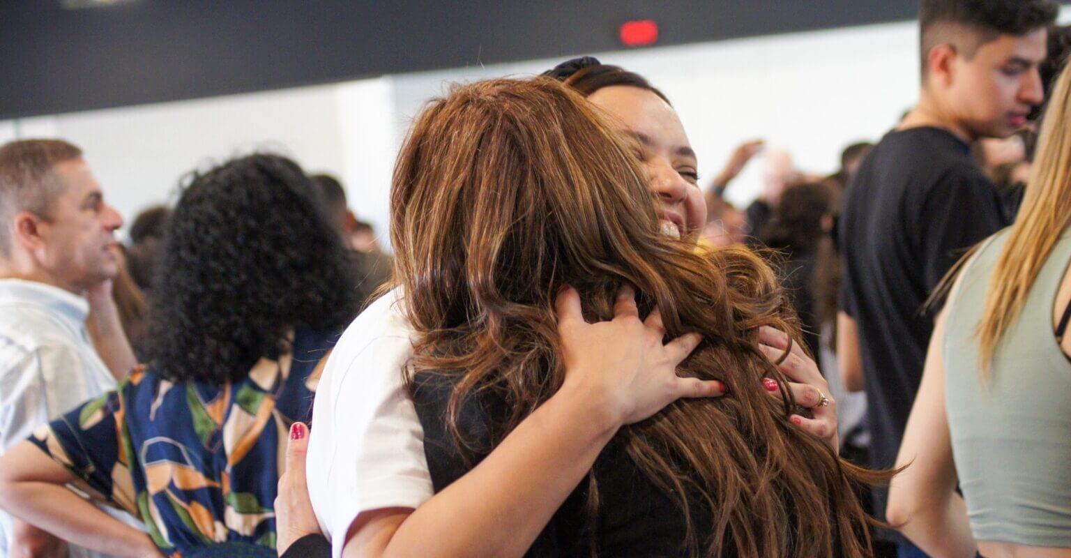 Sisters embracing each other emotionally at the European conference