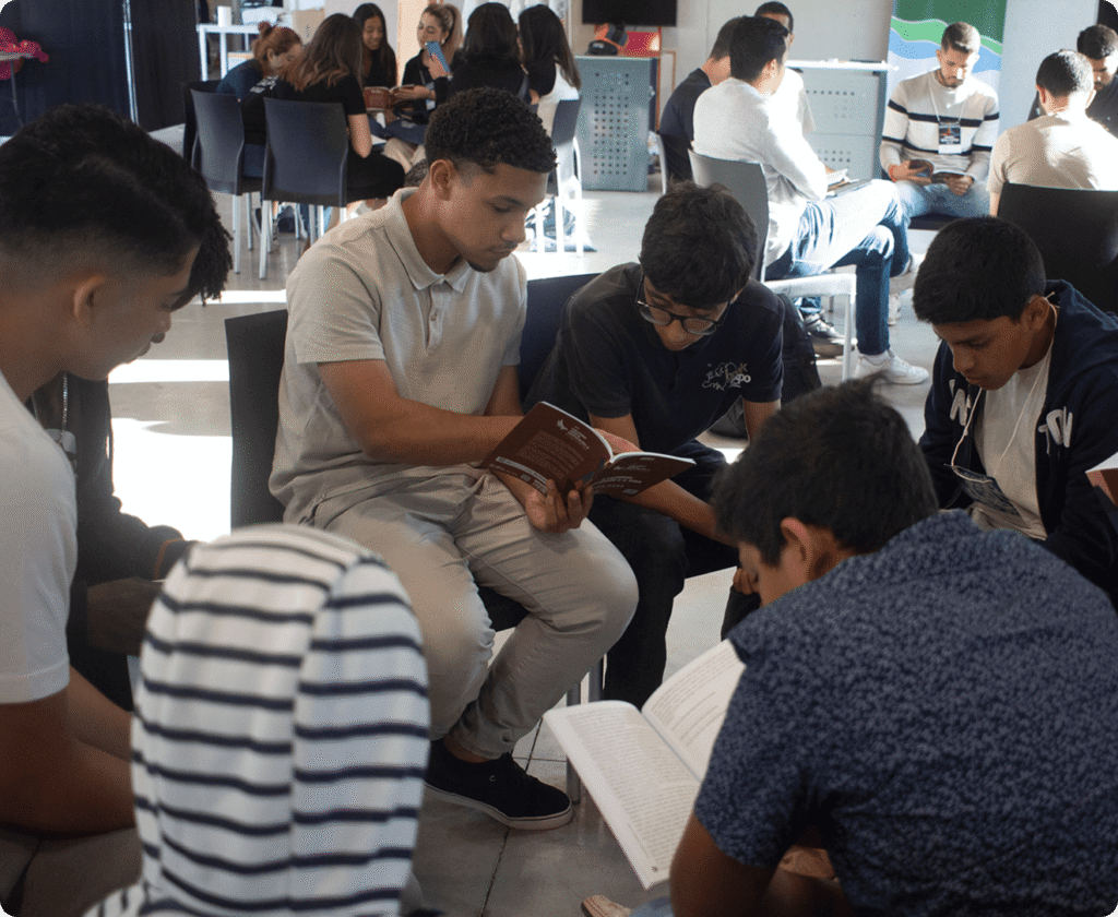 Young members reading a devotional together in a group